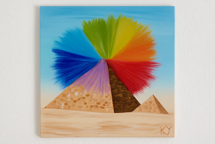 Peinture artistique représentant des pyramides avec une explosion de couleurs symbolisant l’éveil et l’énergie intérieure